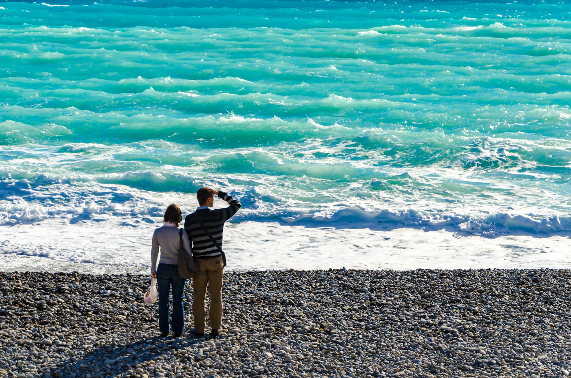 Couple looks out at ocean, illustrating the idea of someone looking for a ghostwriter personality that matches their needs.