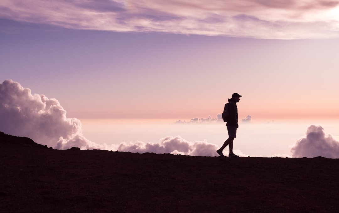 A silhouetted man walks across the horizon, illustrating how ghostwriting works: often unseen, but working for you.